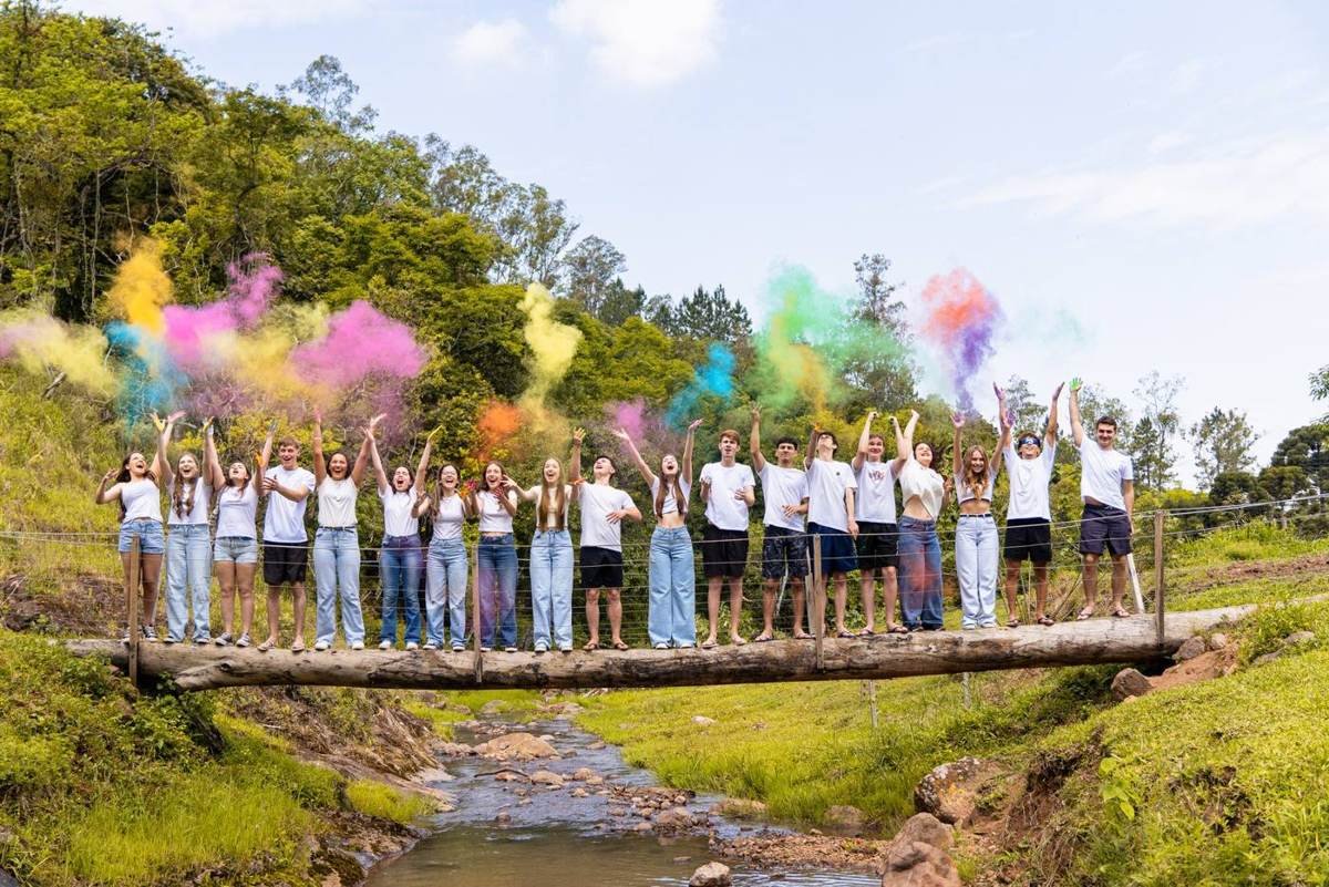 Turma na ponte com fumaça colorida na guerra de tintas